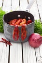 Fresh boiled crawfish with onion and parsley on the white wooden background. Rustic style. Fresh seafood. Steamed crayfish. Royalty Free Stock Photo