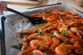 Fresh boiled prawns with coriander on protvin. The cook puts a spatula on juicy seafood. Delicious dish for gourmets Royalty Free Stock Photo