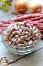 Fresh borlotti or cranberry beans on wooden background