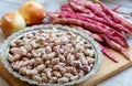 Fresh borlotti or cranberry beans on wooden background