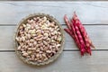 Fresh borlotti or cranberry beans on wooden background