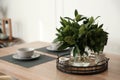 Fresh bouquet on dining table in room, closeup. Interior design Royalty Free Stock Photo