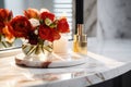 Fresh bouquet of flowers and perfume bottle on marble dressing table with mirror in bathroom