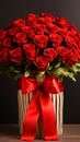 A fresh bouquet of red roses in a stylish package with a ribbon and a bow