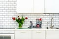 Fresh bouquet of red and white tulips on kitchen table. Detail of home interior, design. Minimalistic concept. Flowers Royalty Free Stock Photo