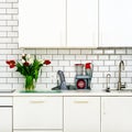 Fresh bouquet of red and white tulips on kitchen table. Detail of home interior, design. Minimalistic concept. Flowers Royalty Free Stock Photo