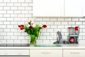 Fresh bouquet of red and white tulips on kitchen table. Detail of home interior, design. Minimalistic concept. Flowers Royalty Free Stock Photo