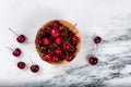 Fresh bowl of sweet red cherries on marble stone countertop Royalty Free Stock Photo