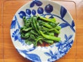 fresh braised green vegetables in the blue plate Royalty Free Stock Photo