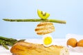 Fresh Bread, Asparagus, Kiwi and Egg. Ingridients for Breakfast. Equilibrium floating food. Balance levitation Food.