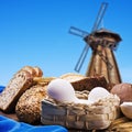 Fresh bread on the background of the wooden mill