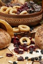 Fresh bread, bagels, dried fruits, seeds, salt, jar and wheat on the wooden - still life and healthy eating concept Royalty Free Stock Photo
