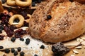 Fresh bread, bagels, dried fruits, seeds, salt, jar and wheat on the wooden - still life and healthy eating concept Royalty Free Stock Photo