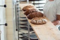 Fresh bread on a board in bakehouse of bakery