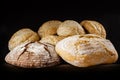 Fresh bread and buns with sesame on dark background. Royalty Free Stock Photo