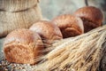 Fresh bread buns, wheat ears and sack of flour. Royalty Free Stock Photo