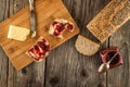 Fresh bread with butter and fruit marmelade served on wooden plate, breakfast in rustic style Royalty Free Stock Photo