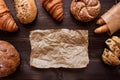 Fresh bread on the dark wooden background top view