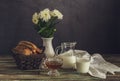 The fresh bread, honey and milk and a vase with white daisies Royalty Free Stock Photo