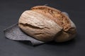 Fresh bread lies on a gray material. Black background. Appetizing bread close-up