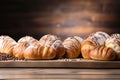 Fresh bread, loaf, buns on a wooden surface, empty background with copy space.