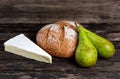 Fresh Bread with Pear and cheese on old wooden table Royalty Free Stock Photo