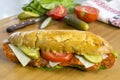 Fresh Bread Roll Filled With Pepperoni, Cheese, Cucumber, Tomato and Lettuce Royalty Free Stock Photo