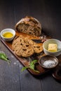 Fresh bread slice with sage butter, olive oil and salt on rustic table on cutting board Royalty Free Stock Photo