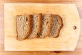 Fresh bread slices on rustic wooden board Royalty Free Stock Photo