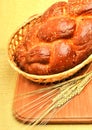 Fresh bread and wheat ear on the wood