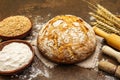 Fresh bread with wheat ears and a bowls of flour and grain Royalty Free Stock Photo