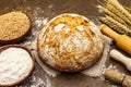 Fresh bread with wheat ears and a bowls of flour and grain Royalty Free Stock Photo