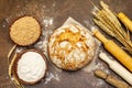 Fresh bread with wheat ears and a bowls of flour and grain Royalty Free Stock Photo