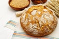 Fresh bread with wheat ears and a bowls of flour and grain Royalty Free Stock Photo