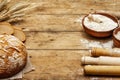 Fresh bread with wheat ears and a bowls of flour and grain, rolling pins Royalty Free Stock Photo