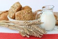 Wheats sticks, `fresh bread and milk on white background. Royalty Free Stock Photo