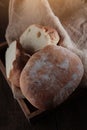 Fresh bread in a wooden box.Italian bread ciabatta or bun. Freshly baked traditional bread. Small depth of field Royalty Free Stock Photo