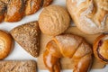 Fresh breads and pastries on white table Royalty Free Stock Photo
