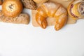 Fresh breads and pastries on white table. Space for text Royalty Free Stock Photo