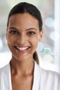 For fresh breath and shiny teeth. Portrait of a smiling woman holding a toothbrush. Royalty Free Stock Photo