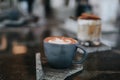 Fresh brewed coffee beautiful cup of cappuccino with latte art in the wooden space background. Trendy toning Royalty Free Stock Photo