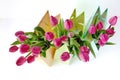 Fresh bright bouquet of pink tulip in paper bags. Beautiful greeting card. Spring holidas concept