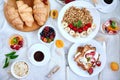 Fresh and bright continental breakfast table, abundance healthy meal variety crunch cereal, french toast, fruits, lemonade, coffee Royalty Free Stock Photo