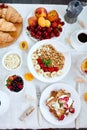 Fresh and bright continental breakfast table, abundance healthy meal variety crunch cereal, french toast, fruits, lemonade, coffee Royalty Free Stock Photo