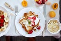 Fresh and bright continental breakfast table, abundance healthy meal variety crunch cereal, french toast, fruits, lemonade, coffee