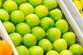 Fresh bright green apples are arranged neatly in a row in a box on the market in the supermarket counter Royalty Free Stock Photo