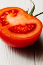 Fresh bright red tomato close-up cut, half tomato, on white background, isolated Royalty Free Stock Photo