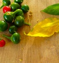 Fresh bright vegetables on a wood background. Green pepper, red chilli pepper. Autumn still life.