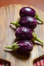Fresh Brinjals Group Eggplant or Aubergine on Wooden Chopper Board