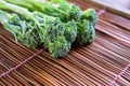Fresh broccoli on bamboo close up